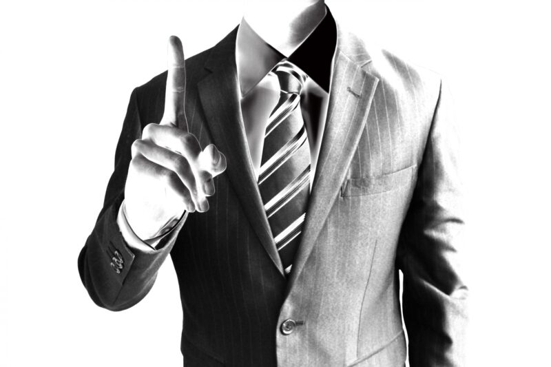 人差し指を立てているビジネスマン